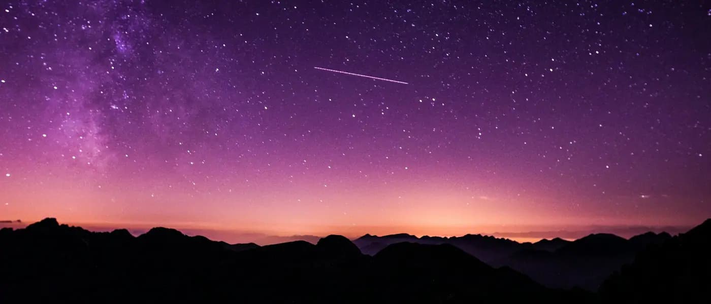 Night sky over a mountain horizon for astrology marketing services