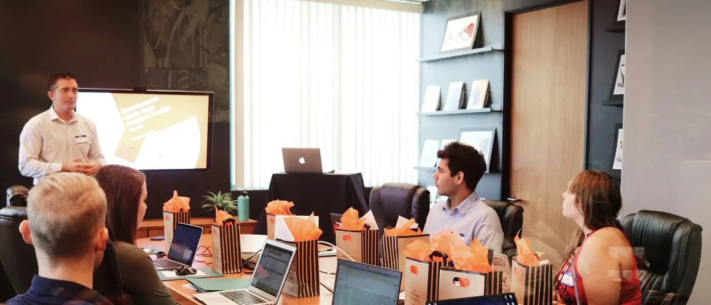 Team meeting around a long table for startup PR agency