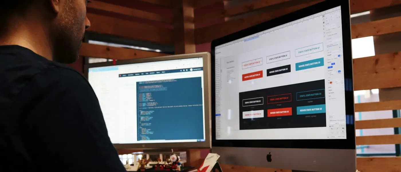 Designer building a website on a desktop monitor for website design and development