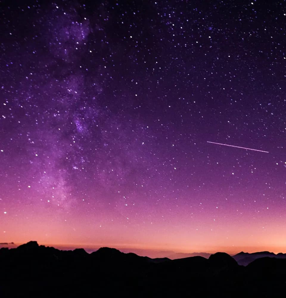 Night sky over a mountain horizon representing astrology SEO